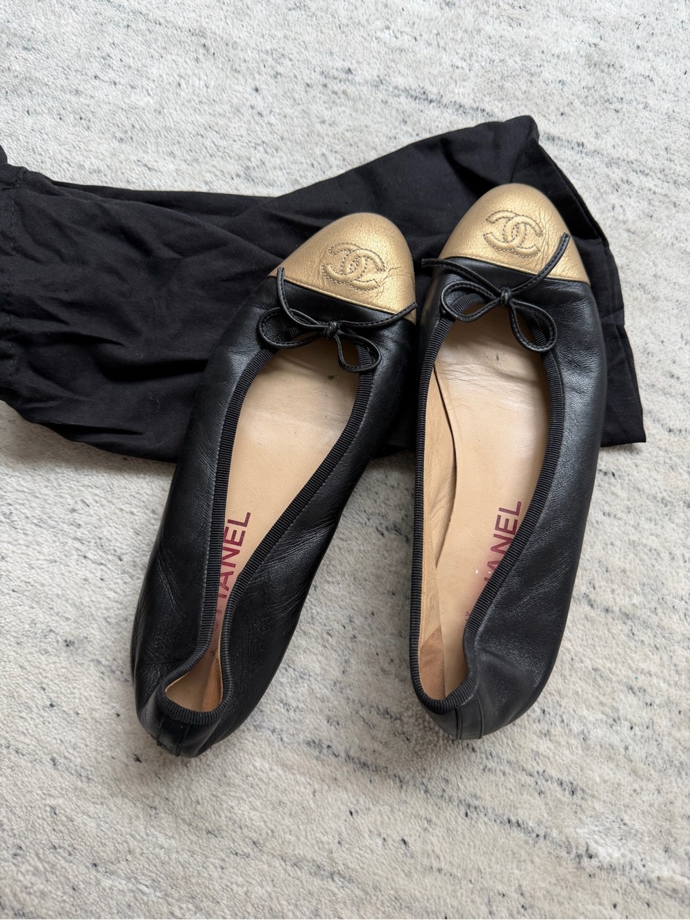 CHANEL Black Leather Ballet Flats with Gold Cap Toe